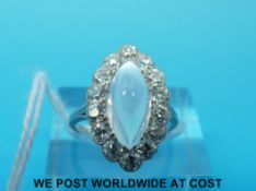 An Art Deco ring set with a moonstone surrounded by old cut diamonds in a navette shaped setting