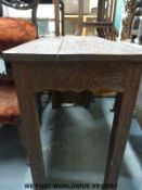 A 19thC carved oak hall table with shaped aprons all round (H83 x W113X D50cm)
