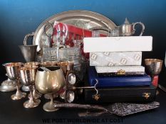 A quantity of silver plate to include several boxed sets of flatware, glass decanters,