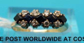 A yellow metal ring set with diamonds and sapphires (size O)
