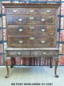 An 18thC walnut and mahogany chest of three over three graduated drawers on a stand with two