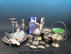 A quantity of silver plate to include a salver, candelabra, cream jugs,