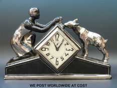 An Art Deco ceramic cased mantel clock timepiece with girl feeding a lamb to top,