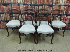 Six Victorian mahogany balloon back chairs with serpentine fronts and cabriole front legs