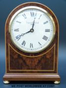 An Asprey and Garrard mantel timepiece in burr walnut and inlay decorated arch case,