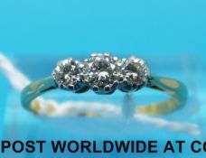 A yellow metal ring marked 18ct set with three diamonds in a platinum setting (size N)