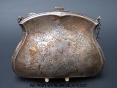A hallmarked silver purse with chased bow and floral decoration,