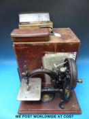 A Wilcox and Gibbs sewing machine and accessories