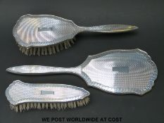 A hallmarked silver three piece dressing table set