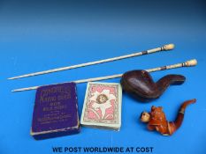 A cased Meerschaum pipe, playing cards and a pair of carved bone knitting needles,