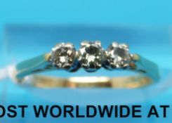 An 18ct gold ring set with three round brilliant cut diamonds (size K)