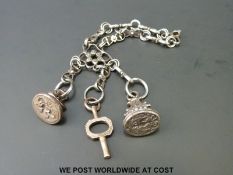 An 18thC cut steel chatelaine with two fobs, one with lion passant,