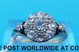 A yellow metal ring marked 18ct gold set with diamonds in a cluster (size M)