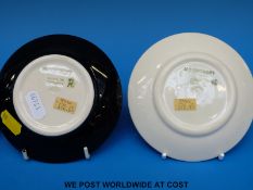 A small Moorcroft pin dish decorated with a butterfly and another with an abstract violet design