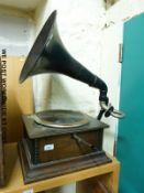 A vintage wind up gramophone with painted metal horn