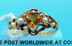 A 15ct gold ring set with a heart shaped citrine and seed pearls with scrolling design to the