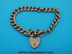 A 9ct gold curb link bracelet with padlock clasp (14.