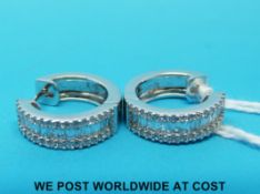 A pair of 18ct white gold earrings set with baguette cut and round brilliant cut diamonds