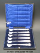 An unusual cased set of six hallmarked silver handled eating cutlery with half moon and point tools
