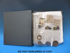 A folder containing a collection of various bronze medals etc,