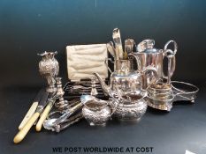 A collection of silver plate including a tankard, a boxed grape and nut cracker set, several vases,