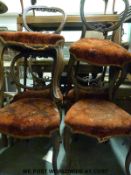 A set of six Victorian carved and moulded mahogany balloon-backed chairs with serpentine fronts,