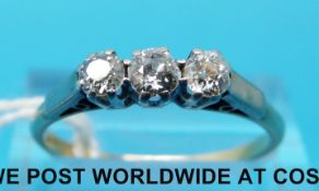 An 18ct gold ring set with three diamonds in a platinum setting (size R/S)