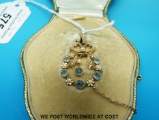 An Edwardian pendant marked 15ct set with seed pearls and topaz,