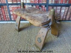 A camel stool with tooled leather seat (H30 x L64 x D38cm)