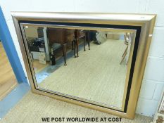 A large cushion framed bevelled glass mirror (102 x 125cm)