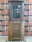 A 19thC oak astragal glazed corner cupboard with dentil moulded cornice,