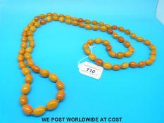 An amber necklace consisting of 82 ovoid beads each measuring approximately 2 x 1.
