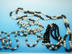 A necklace made up of black and natural coloured pearl beads,