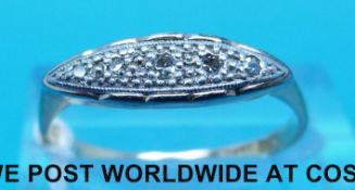 A yellow metal ring set with five diamonds in a platinum setting