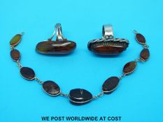 Two white metal rings set with pressed amber and an amber bracelet