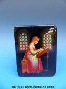 A small, hinged lacquered box decorated with a young girl doing needlepoint, signed by the artist,