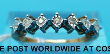 An 18ct gold ring set with seven diamonds (size O/P)