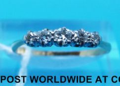 A yellow metal ring marked 18ct set with five diamonds in a platinum setting (size O)