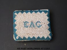 A dated 1837 beadwork pin cushion in the form of a book (5 x 4.