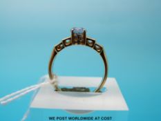 An 18ct gold ring set with an oval sapphire and baguette cut diamonds (6g,