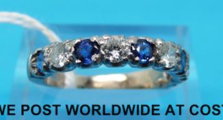 A white metal half eternity ring set with alternating sapphires and diamonds (size M)