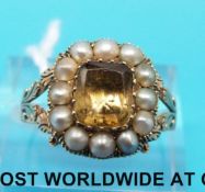 A Victorian ring set with a smoky quartz surrounded by seed pearls with foliate design to the