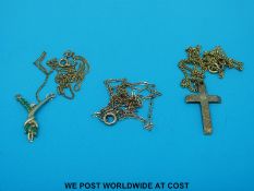 A gold diamond and emerald pendant cross and chains (9.