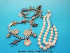 A two strand pearl bracelet and two silver charm bracelets