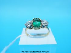 An 18ct gold ring set with an emerald cut emerald of approximately 1.