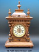 A Wurttemberg mantel clock in light oak case with turned decoration and ivory coloured dial,