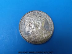 A cased medal coin in sterling silver commemorating King George and Queen Mary's Jubilee 1935