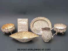 A quantity of Indian / Burmese white metal items to include a card case, bowls,