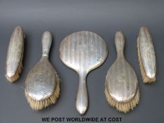 A hallmarked silver five piece dressing table set