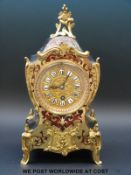 A French Boulle work mantel timepiece with ebonised case raised on brass feet,